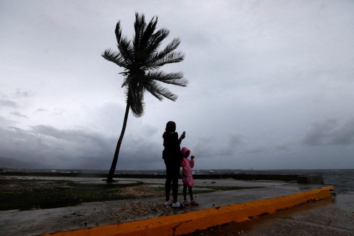 A woman and a child stand along the Kingston waterfront as Hurricane Melissa approaches, in Kingston, Jamaica.  REUTERS/Octavio Jones