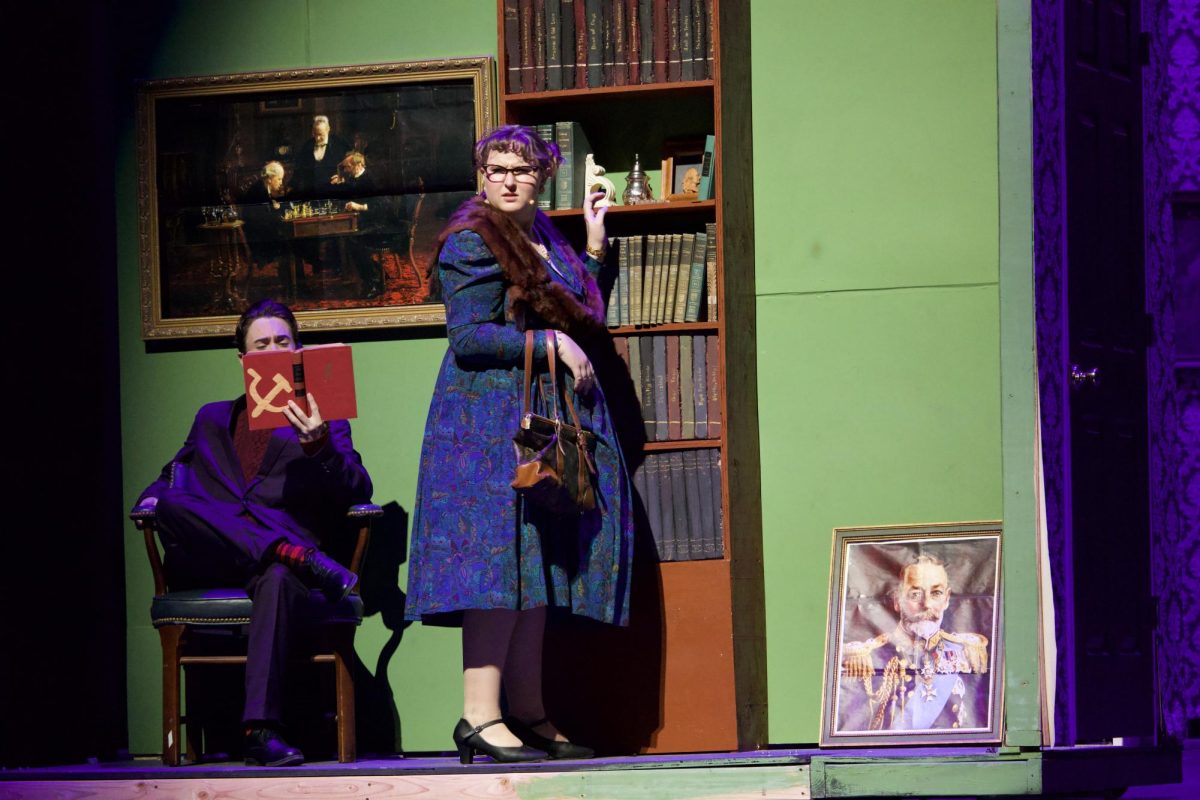Finn Pryor (Professor Plum) with some interesting reading material and Ann Picarello (Mrs. Peacock) looking for evidence. 