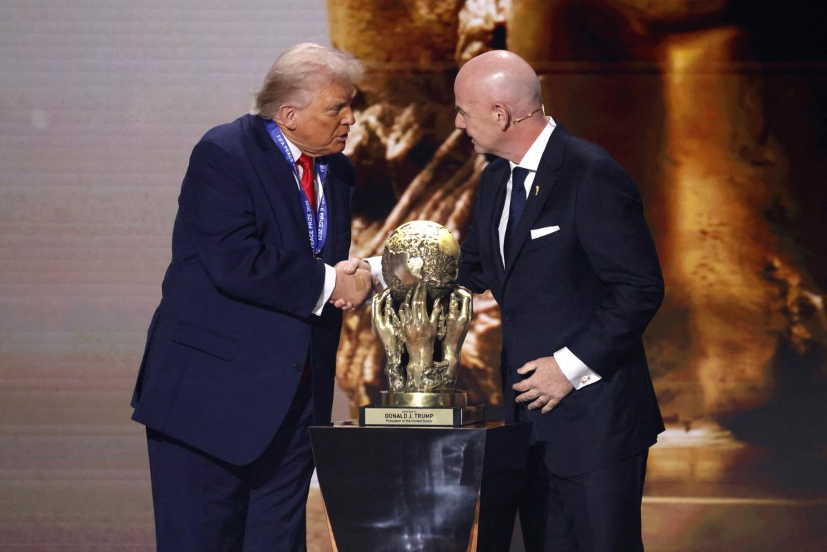 Dec 5, 2025; Washington, District of Columbia, USA; FIFA president Gianni Infantino presents United States president Donald Trump with the FIFA Peace Prize during the FIFA World Cup 2026 Final Draw at John F. Kennedy Center for the Performing Arts. Mandatory Credit: Amber Searls-Imagn Images