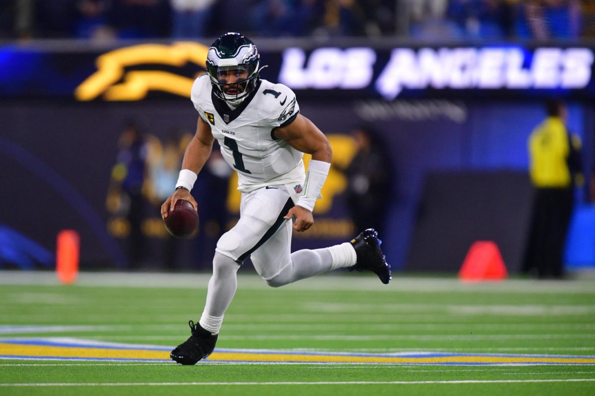 Dec 8, 2025; Inglewood, California, USA;  Philadelphia Eagles quarterback Jalen Hurts (1) runs against the Los Angeles Chargers in the first half at SoFi Stadium. Mandatory Credit: Gary A. Vasquez-Imagn Images