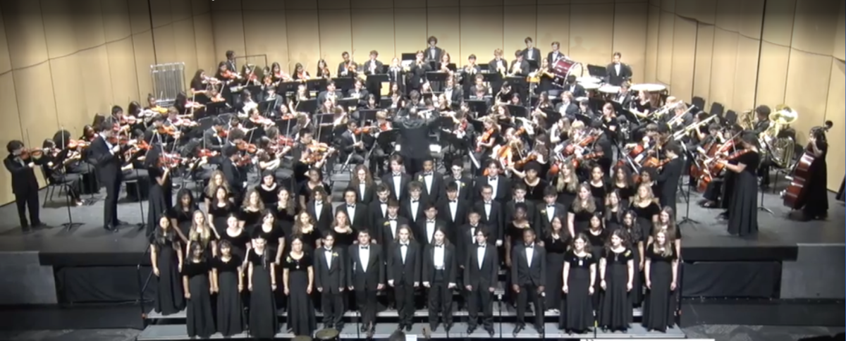 An image of the entire Music department(Band, Orchestra, and Choir) on stage during the grand finale of a previous performance